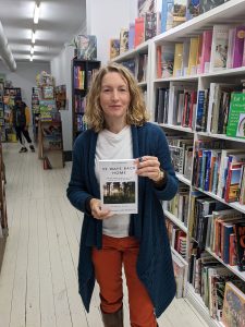 Beccy Howe, author, with first book, 52 Ways Back Home in bookstore