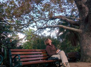 Beccy Howe, author, getting writing inspiration on bench in park